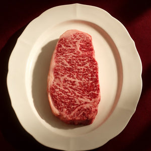 Icon Holiday Box from Standard Meat Club: marbled Wagyu NY strip on a white plate